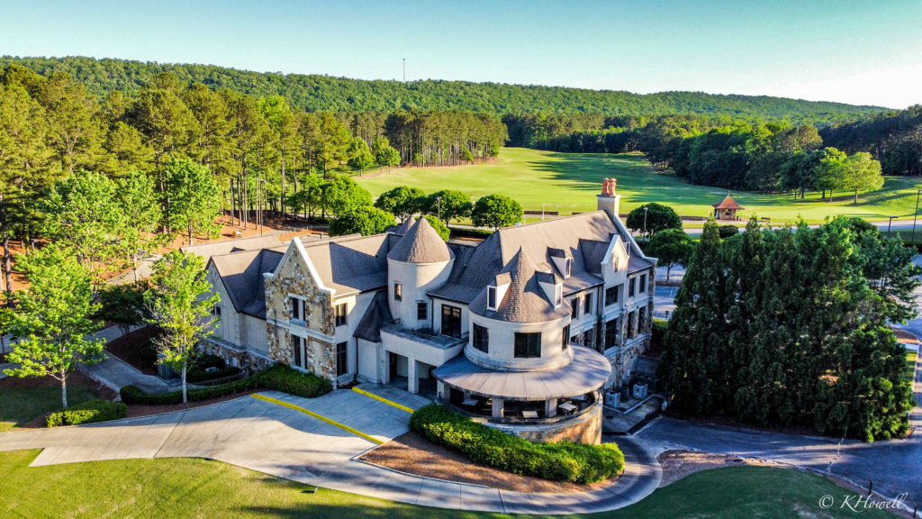 Ballantrae’s stone clubhouse surrounded by green fairways and wooded hills