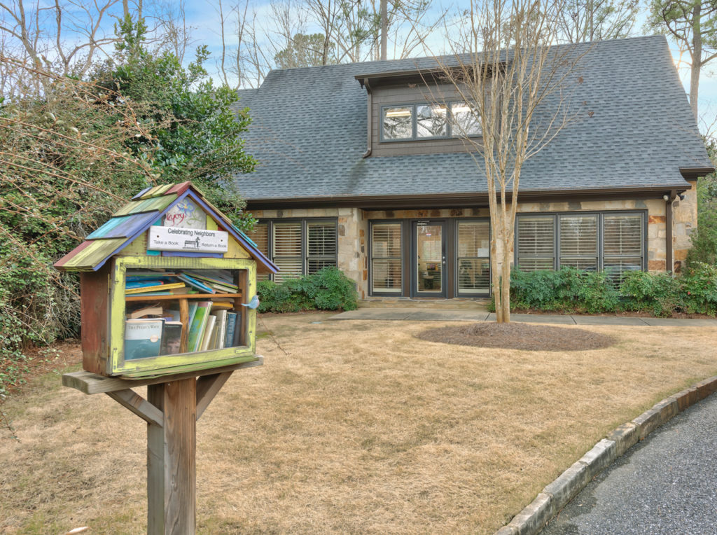 A colorful neighborhood book-sharing library outside a Ballantrae community building