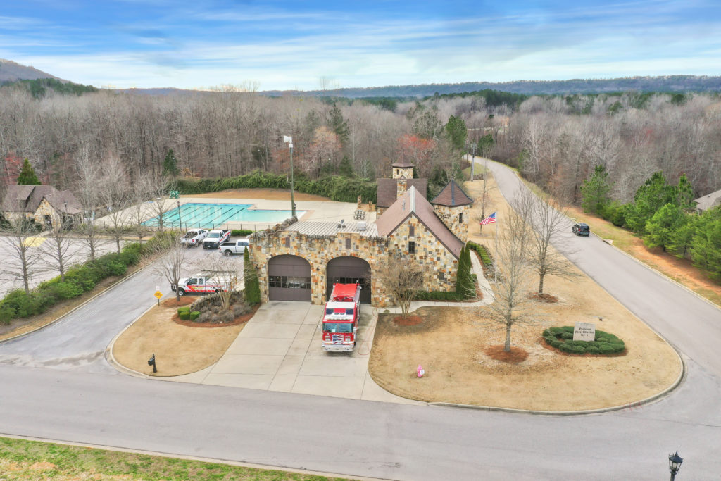 Ballantrae neighborhood streets, stone fire station, and pool in Pelham
